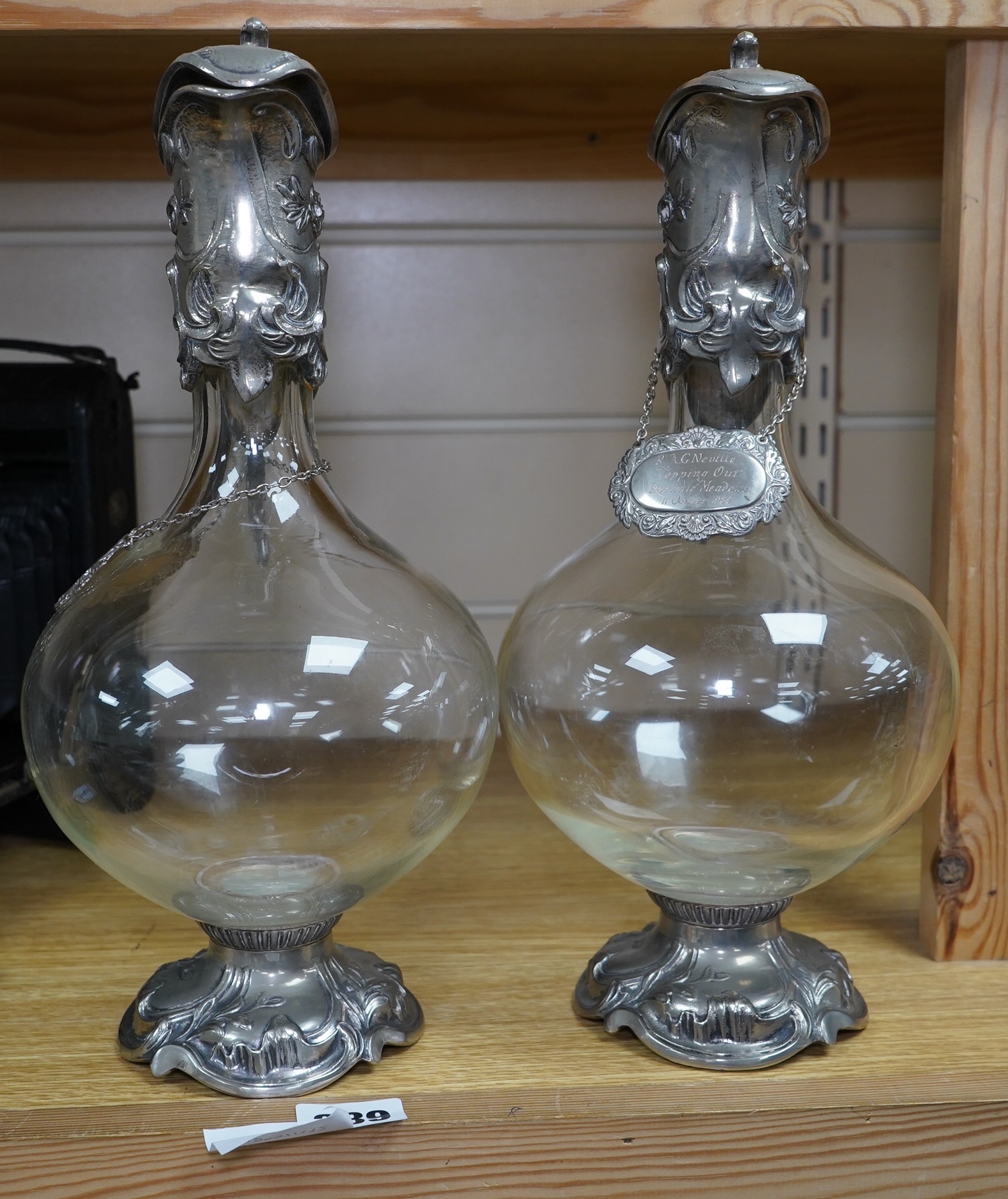 A pair of Art Nouveau silver plate mounted claret jugs with labels, 32cm. Condition - fair to good